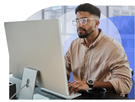 Focused Male Sitting At His Computer Running His Small Business While Using Thryv's Unlimited Support